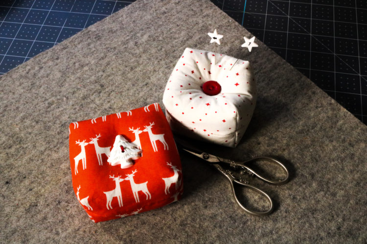 pin cushions with scissors on tabletop