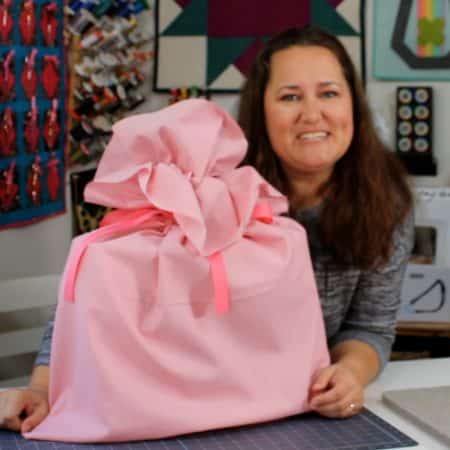 Smiling woman with large fabric gift bag